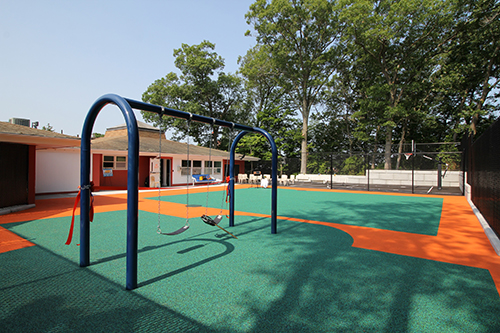 playground with gym bars and green clay court