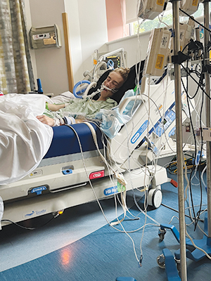 Aiden in hospital bed recovering after surgery