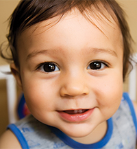 2025 Caring for Kids child's face up close and smiling
