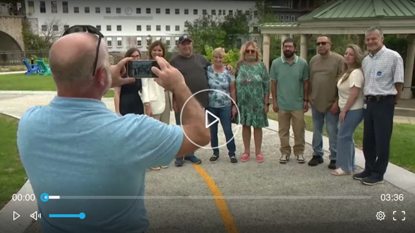 Kidney transplant patients and their families pose together for a group photo