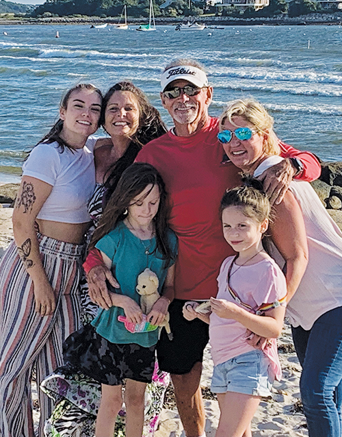 Bruce Barton poses with family at waterfront