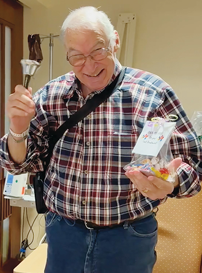 Biz rings a bell during his release from the hospital